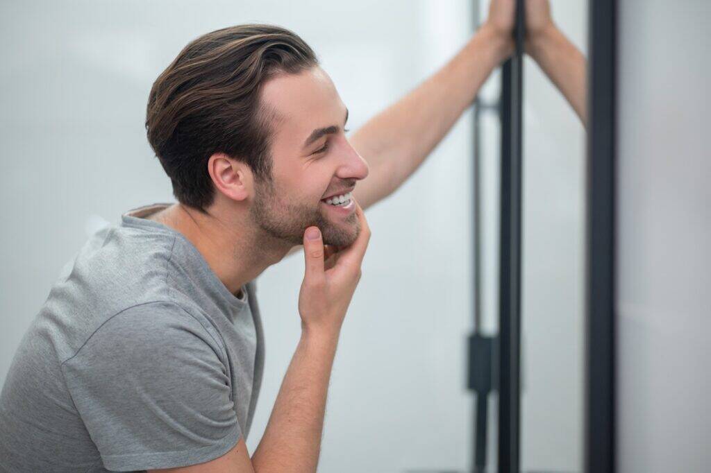 appearance-young-man-grey-tshirt-looking-his-reflection-mirror