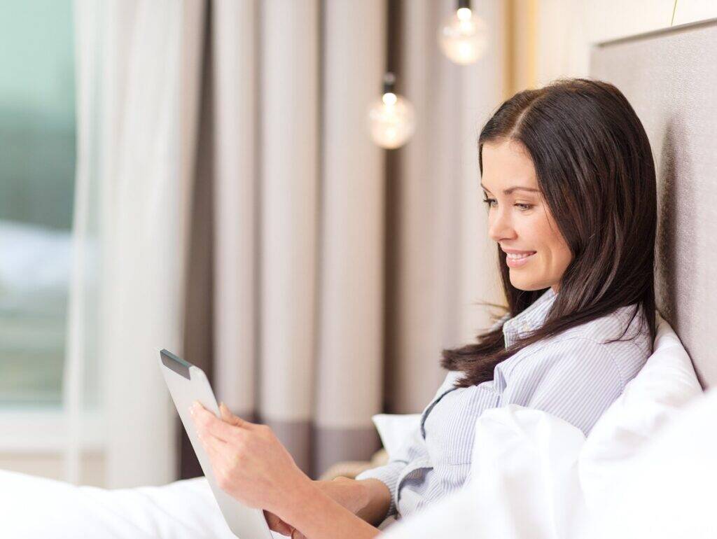 business-technology-internet-hotel-concept-happy-businesswoman-with-tablet-pc-computer-lying-hotel-bed